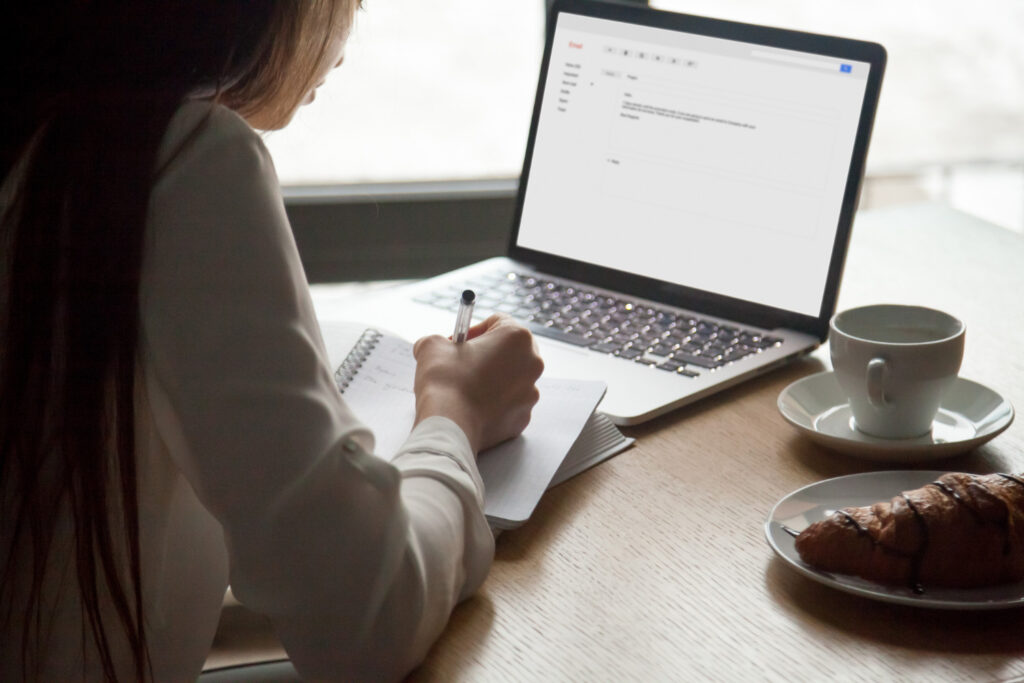 Woman Making Notes Reading Email Letter
